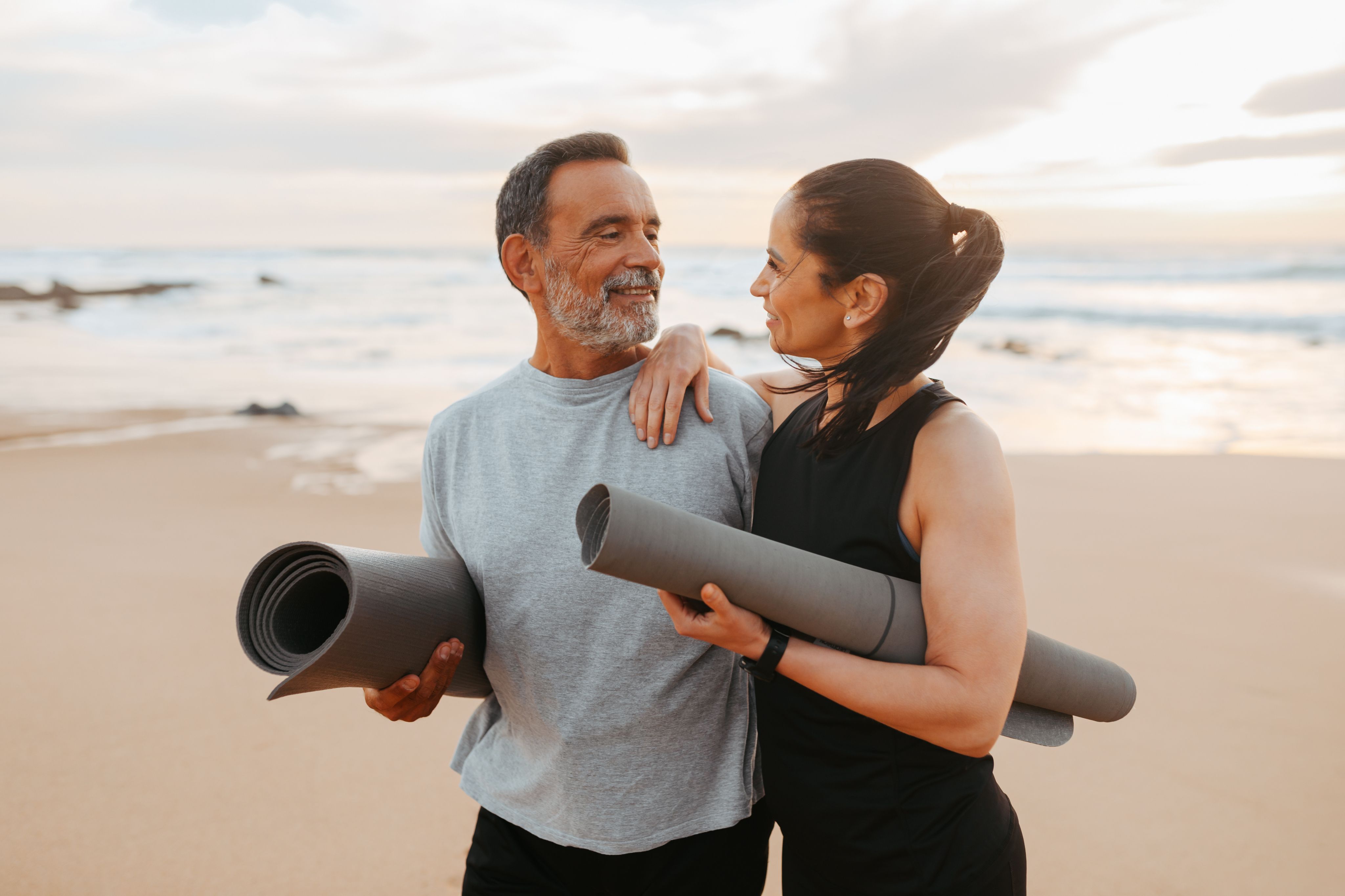 Couple in athletic wear exercising together, showing the lifestyle results of sustainable weight loss.