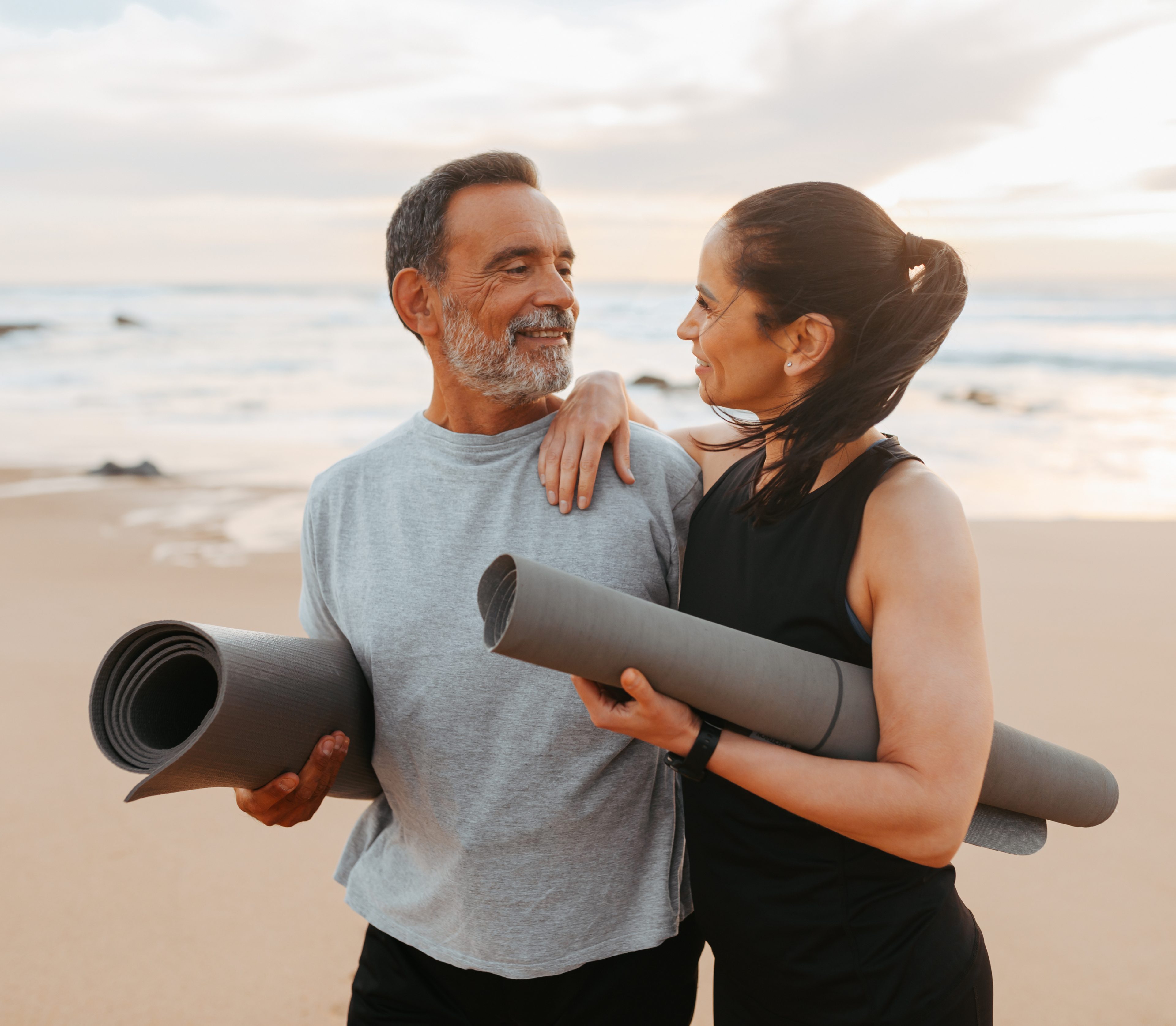 Couple in athletic wear exercising together, showing the lifestyle results of sustainable weight loss.