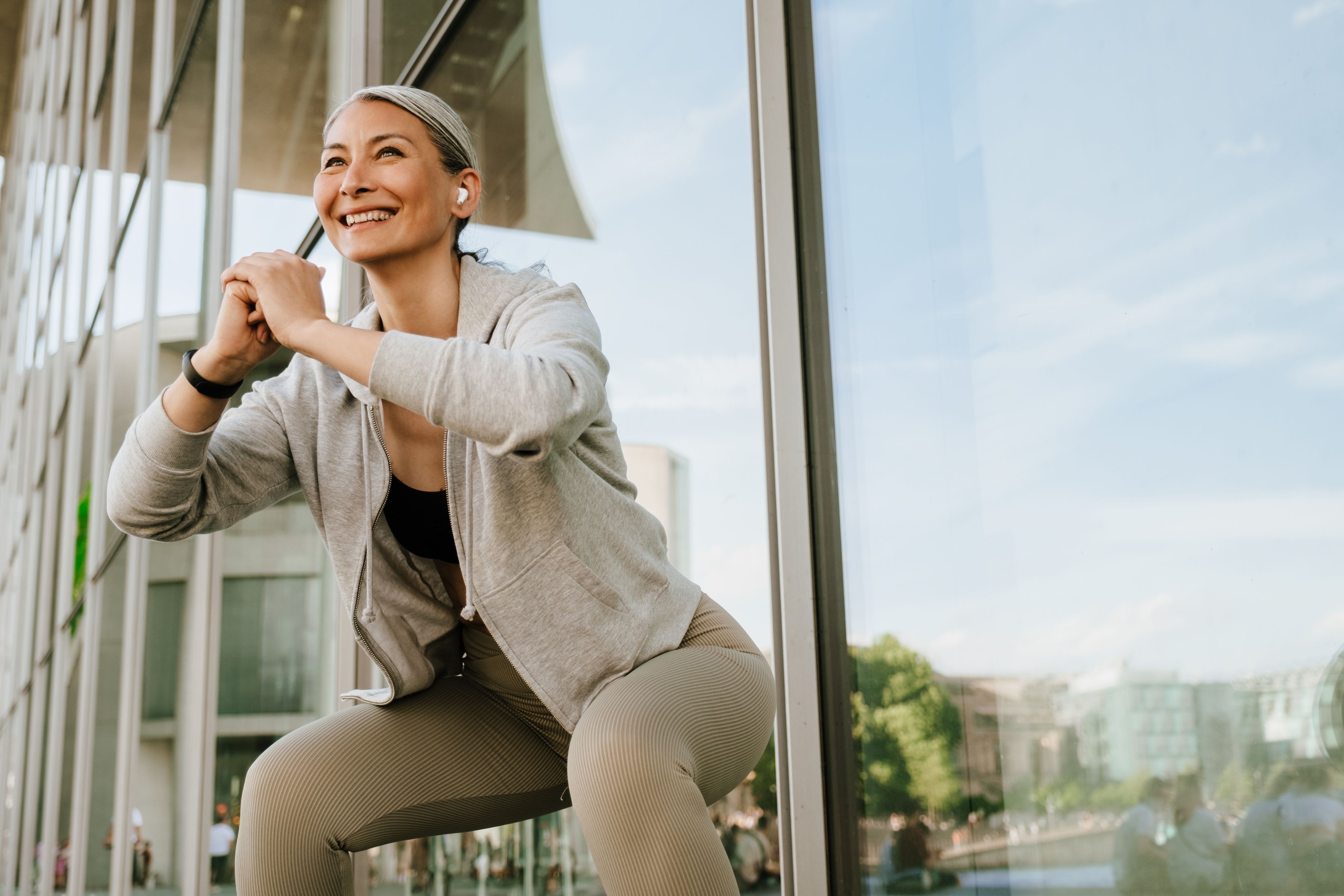 Woman sitting on edge with phone, illustrating the start of a medical weight loss program.