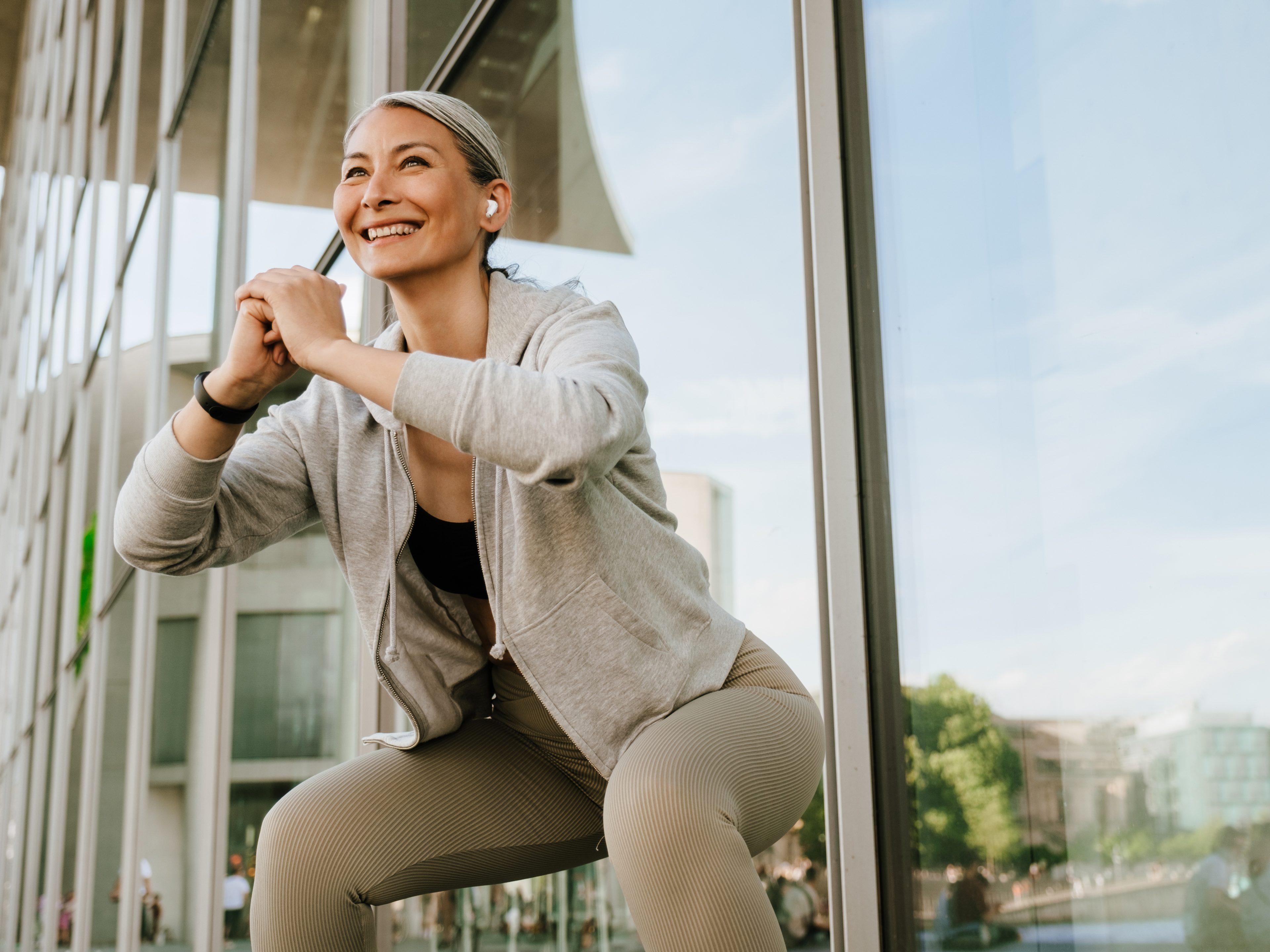 Woman sitting on edge with phone, illustrating the start of a medical weight loss program.