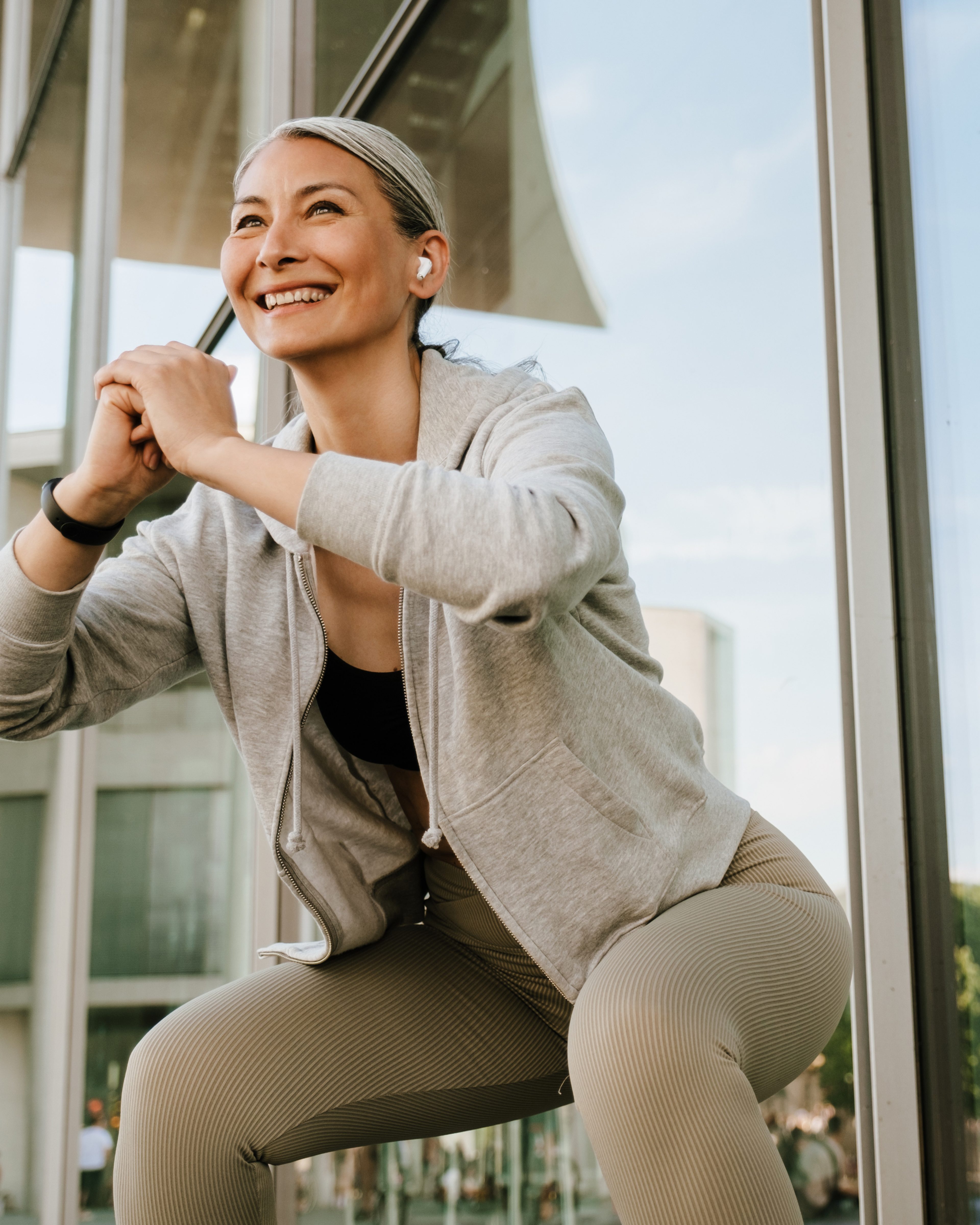 Woman sitting on edge with phone, illustrating the start of a medical weight loss program.